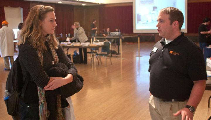 Kody Pratt, junior in theatre, talks to a university representative about off-campus leadership opportunities at the UC Open House on Thursday, Feb. 17.
