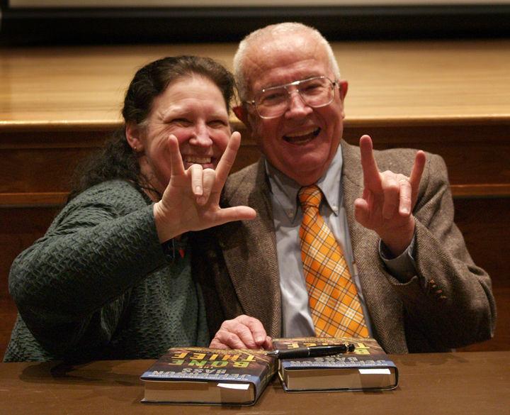 Kimberly Hinchey, sign language interpreter, shows Dr. Bill Bass how to sign "I love you" after his lecture on Tuesday, Feb. 8. Bass, author and founder of the Body Farm, recounted odd tales from his work in the field of forensic science.