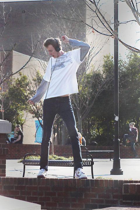 Neil Cole, freshman undecided, dances in Pedestrian Courtyard on Tuesday, March 1. Neil, better know as the Dancing Kid at UT, has garnered plenty of attention thanks to his dancing during seeming all activities, including meals at Presidential Cafeteria.