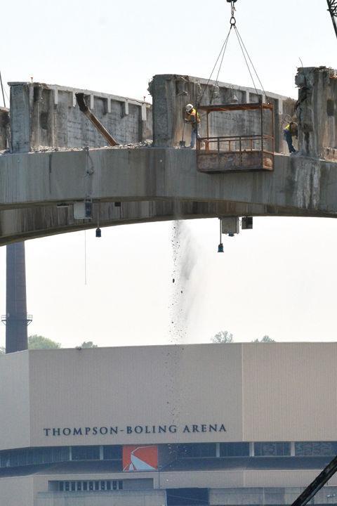 Workers sweep debris from the exposed supports of the Henley Street Bridge on Monday, June 6. The major vein for traffic flow between downtown and South Knoxville closed at the beginning of the year and is scheduled to reopen by the end of June, 2013.