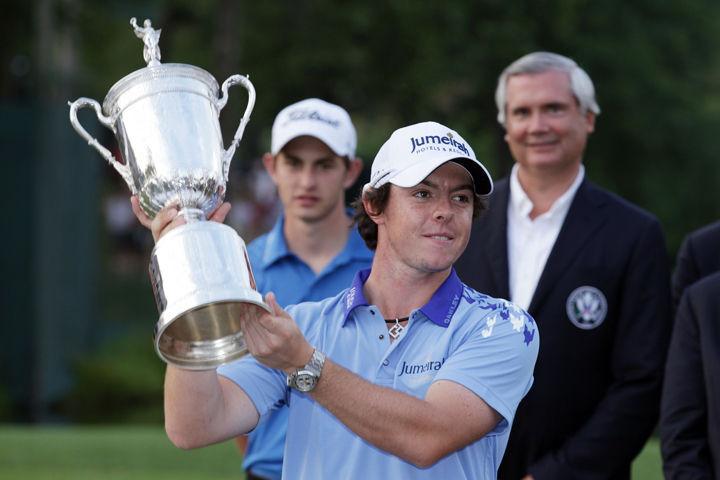 Rory McIlroy poses with the trophy after his eight-stroke victory on the 18th green to win the 111th U.S. Open at Congressional Country Club on Sunday, June 19.