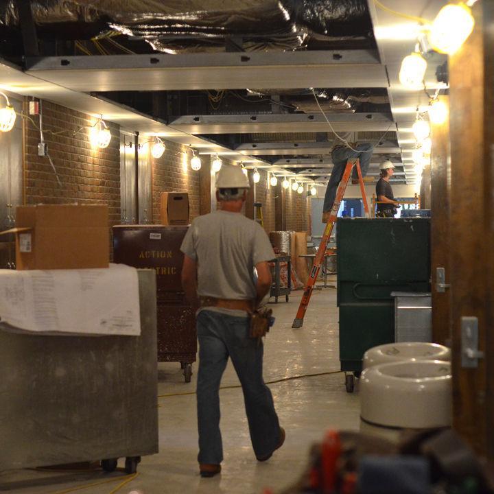 Workers and equipment line the first floor hall of the Humanities Building on Monday, June 13. Construction on the building, which began at the end of the Spring Semester, has continued through the summer to be completed for the return of students in the fall.