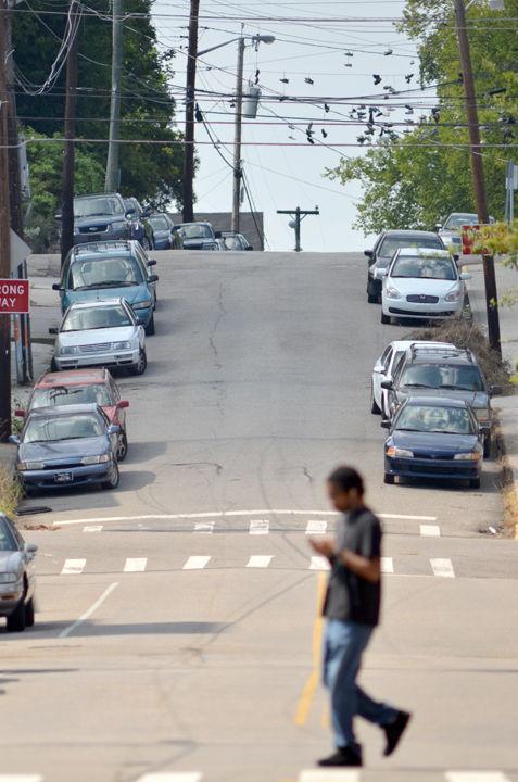 A man walks across James Agee Street near Vol Hall in Fort Sanders on Thursday, July 28. UT recently launched a new safety initiative to increase awareness for residents in the area though dangerous by many UT students.