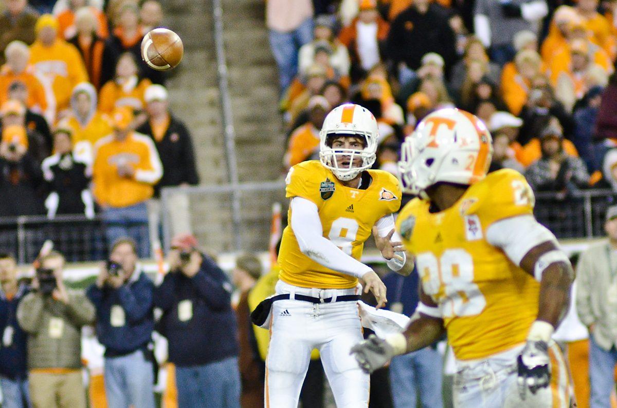 Tyler Bray passes the ball with sights set on Tauren Poole during the Music City Bowl on December 30, 2010. Both Bray and Poole were placed on the Maxwell Award watch list.