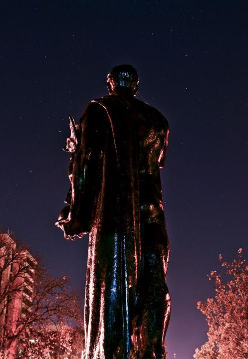 The Torchbearer statue looks out into the night sky on Friday, Nov. 12, 2010. Although the design of the official symbol of the university was created in 1932, the statue was not placed on campus in Circle Park until 1968.
