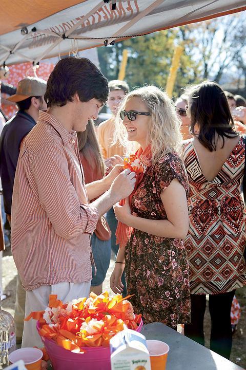 Matthew Keany pins a bow on Madison Cox during the Turkey Tailgate at FIJI Island before a football game against Ole Miss on Saturday, Nov. 13, 2010. This year, the sisters of Phi Mu will be hosting "Chili for the Children," a philanthropic tailgate to benefit the Children's Miracle Network of Hospitals.