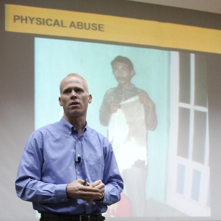 Jim Keady speaks with the audience during a lecture on the business practices of Nike in the UC Auditorium on Wednesday, Nov. 16. Keady gave students a first-person account of the economic and human rights issues that are common in overseas sweat shops operated by the internationally-known company.