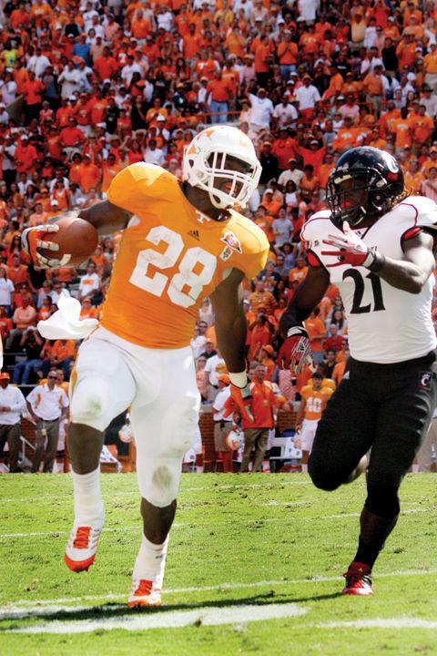 Tauren Poole runs past a Cincinnati defender during a game in Neyland Stadium on Saturday, Sept. 10, 2011. Poole will be playing in the 2012 East-West Shrine Game while teammate Austin Johnson will be playing the Casino Del Sol All-Star Game.