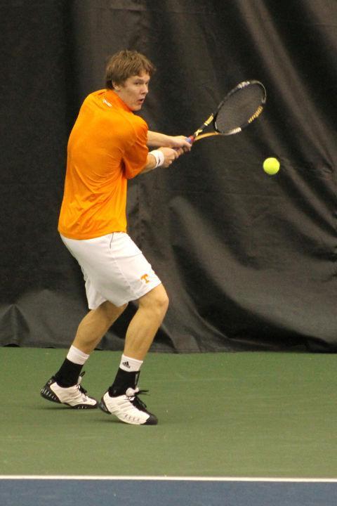 Mikelis Libietis lines up a backhand during a match against an Illinois opponent Feb. 5. Libietis, a freshman, stepped onto the court in the No. 1 spot his first match at UT, the first to have done so since John-Patrick Smith in 2008.