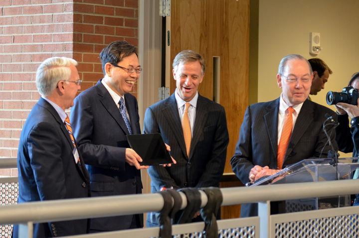 Min H. Kao accepts a digital image frame from College of Engineering Dean Wayne Davis, Tennessee Gov. Bill Haslam and Chancellor Jimmy Cheek at the dedication of the Electrical Engineering and Computer Science building in Kao's name on Wednesday. Kao, who received his M.S. and Ph.D. degrees from UT, donated a transformational gift of $17.5 million to the College of Engineering that was instrumental in raising the building that bears his name.