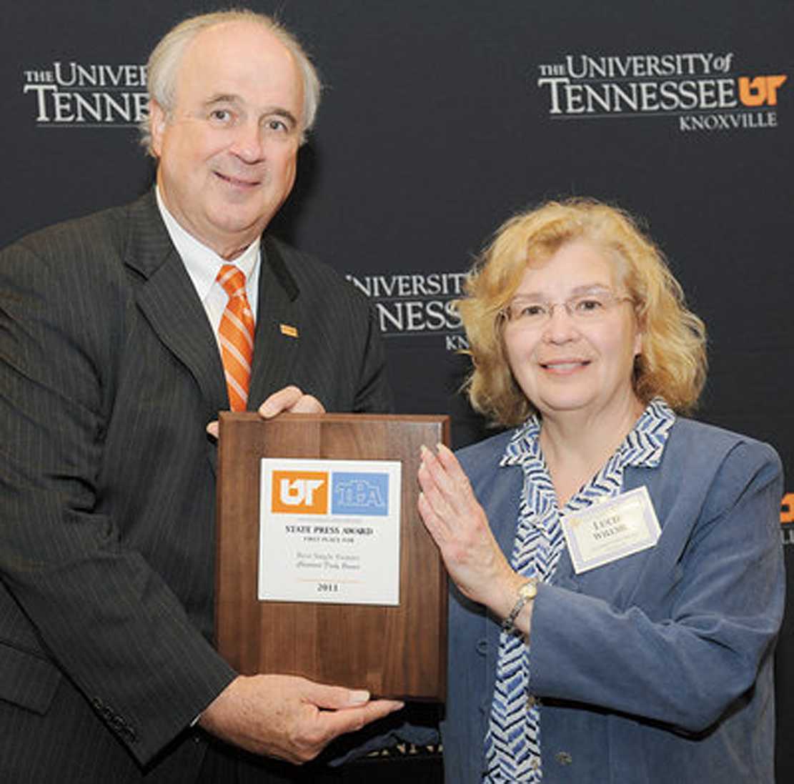 Hank Dye presents the First Place “Best Single Feature” award to Lucie R. Willsie, associate editor of the Cleveland Daily Banner in the 2011 State Press Awards.