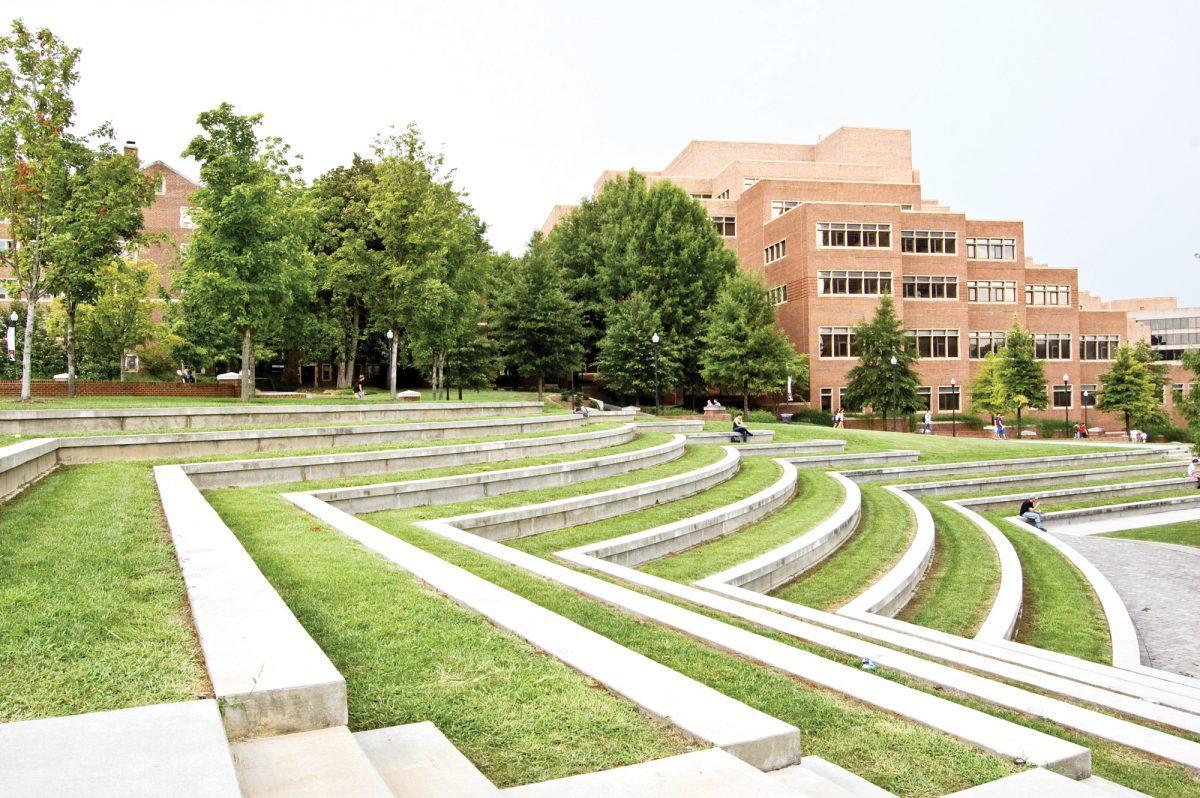 Students sit outside in the amphiteatre in fall 2010. A new study shows that students who finish their undergrad within four years have a higher income than those who take more time.