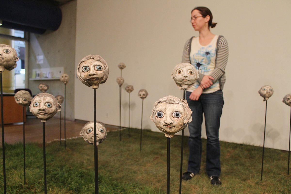 Gretchen Bundy, graduate student in sculpture, walks around the Ewing Gallery examining Amy Hand’s MFA thesis show on April 23. Ewing Gallery is an on-campus art gallery dedicated often to visiting artists as well as the MFA thesis shows. Ewing Gallery is located on the first floor of the Art and Architecture building.