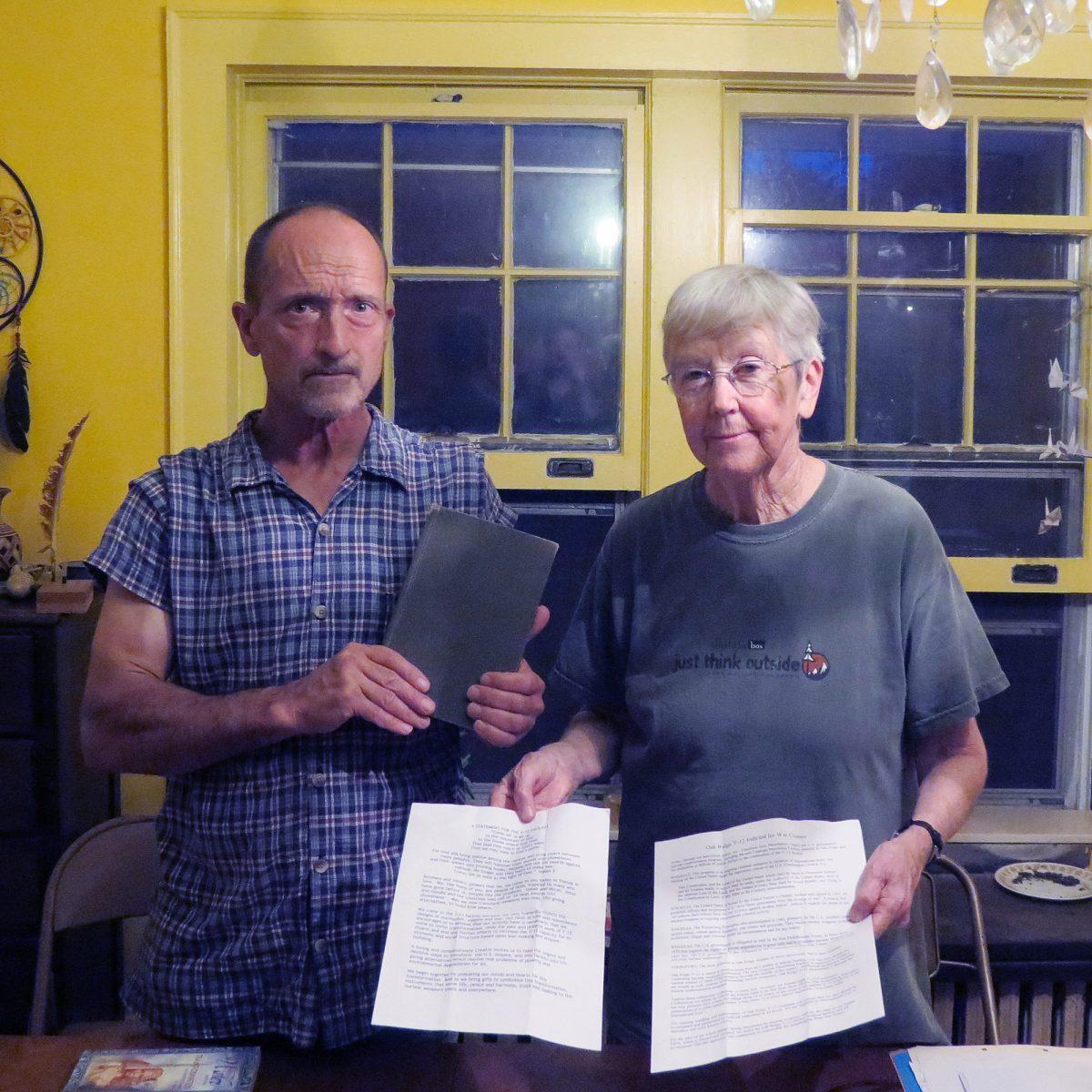 Michael Walli, 63, and Sister Megan Rice, 82, stand in the dining room of a South Knoxville home holding two documents and a bible that they had on their persons during their arrest at the Y-12 Security Complex. Wallie, Rice and Greg Boertje-Obed are charged with misdemeanor trespassing charges and felony charges of destroying or injuring government property. Walli and Rice were both released on conditions by the court on Friday, Aug. 3.
