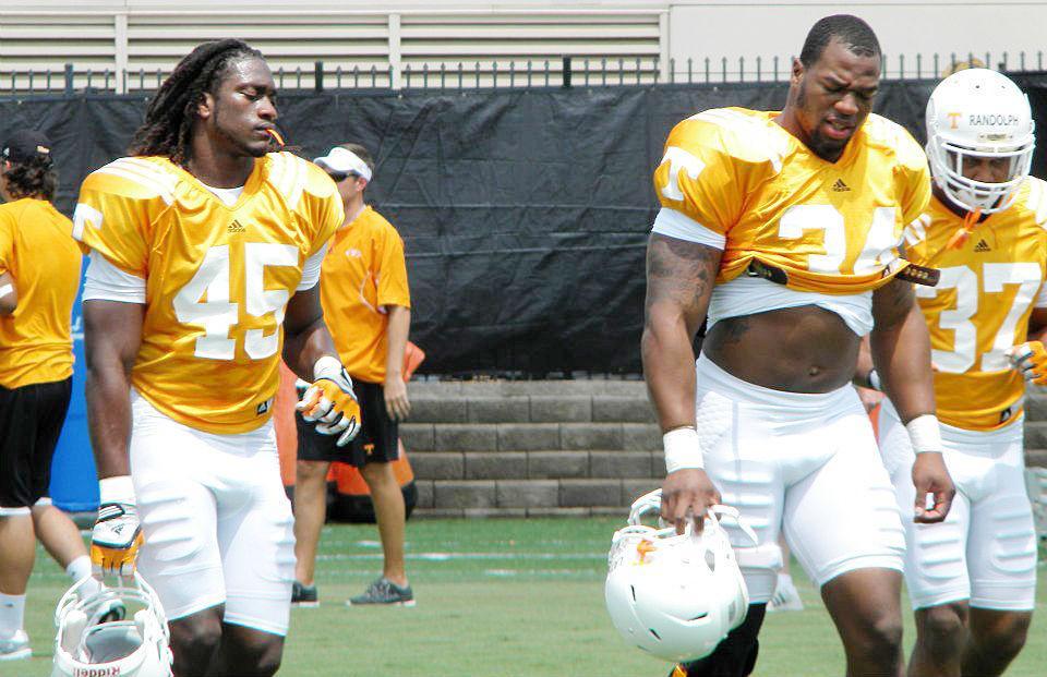 A.J. Johnson and Herman Lathers take a rest during pre-fall camp on Aug. 7.