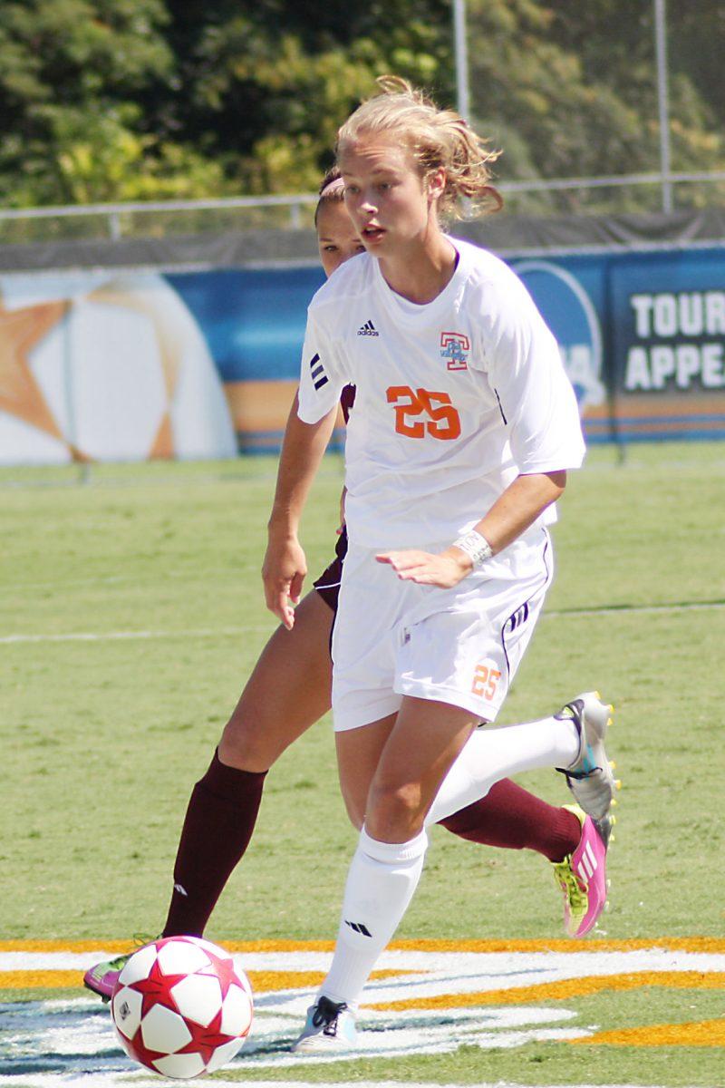 Caroline Brown runs past a Texas A&amp;M player on Aug 28, 2011.