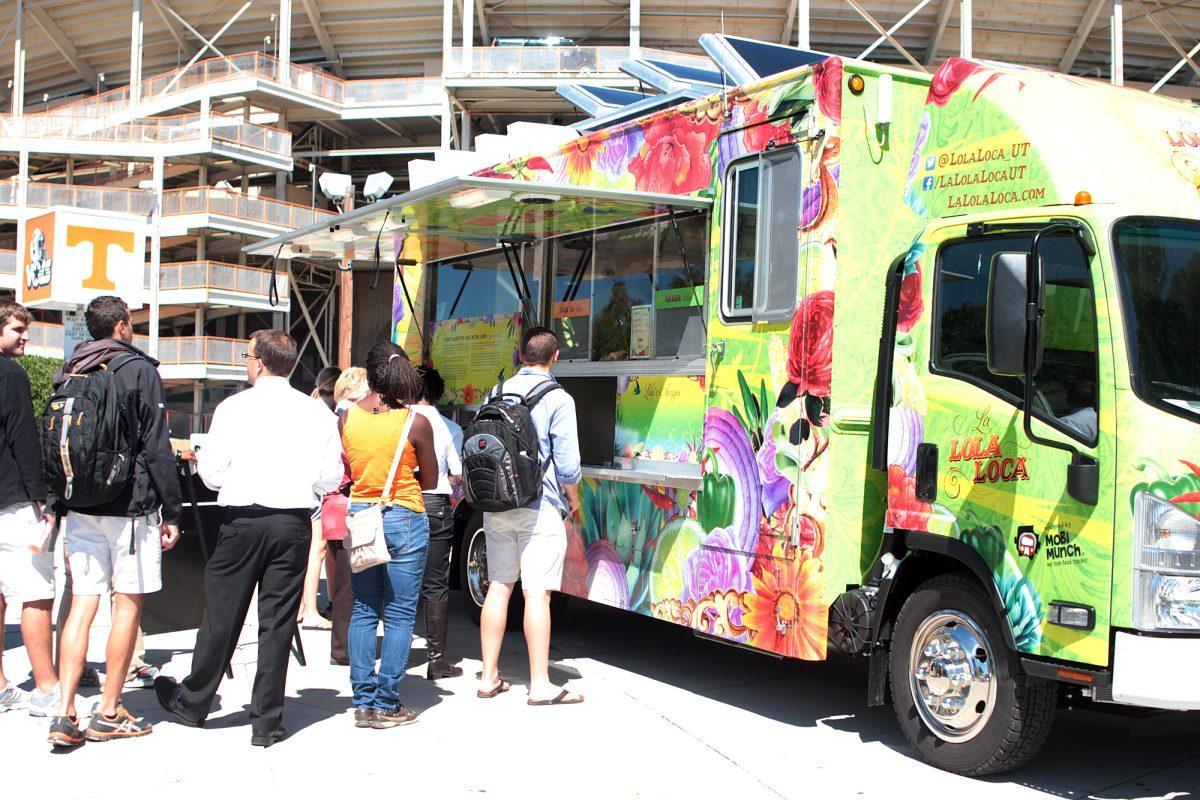 Students and staff line up for the La Lola Loca food truck on Wednesday. For the truck’s trial run they were handing out free food from the menu.