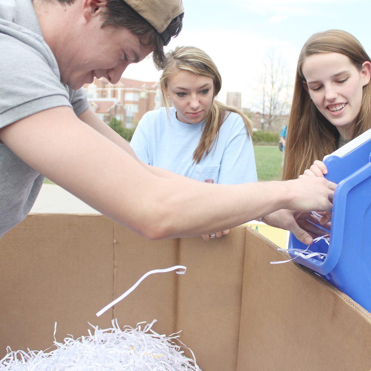 A student searches for bottle caps during RecycleMania on March 15, 2011. UT finished 1st place in the country-wide competition with help of student volunteers and UT recycling staff.