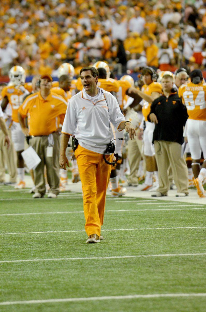 Head coach Derek Dooley yells at the team during a timeout against N.C. State on Aug. 31. Dooley started the season well with a win against N.C. State, but many people now think his job is on the line again after a loss to Miss. State on Saturday.