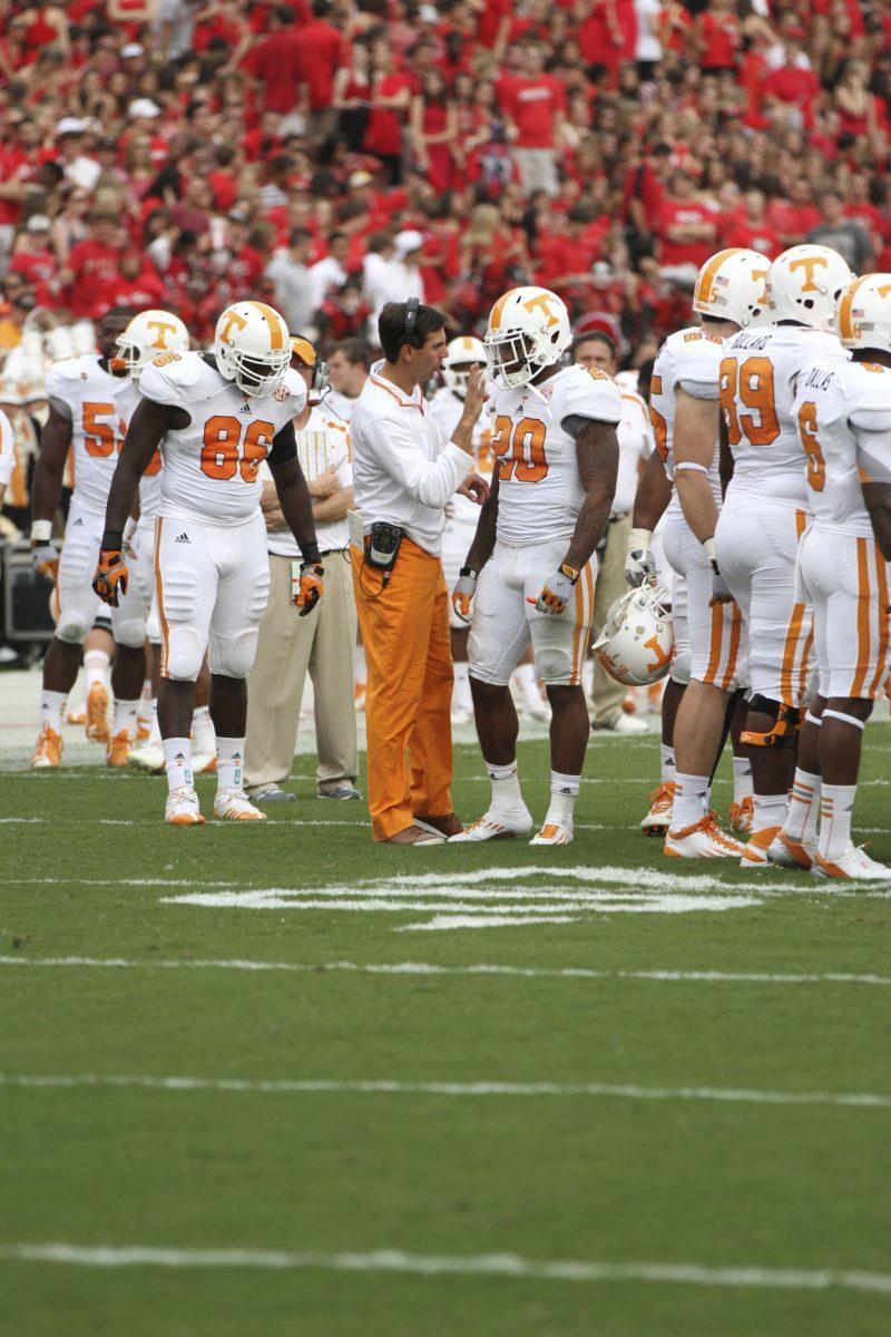 Derek Dooley talks with running back Rajion Neal during the UGA game on Sept. 29.