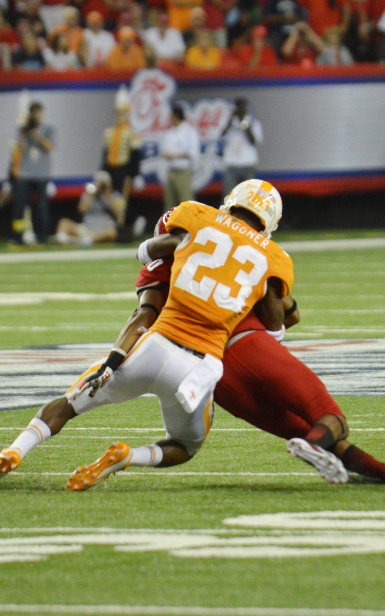 Prentiss Waggner takes down a player from N.C. State on Aug. 31.