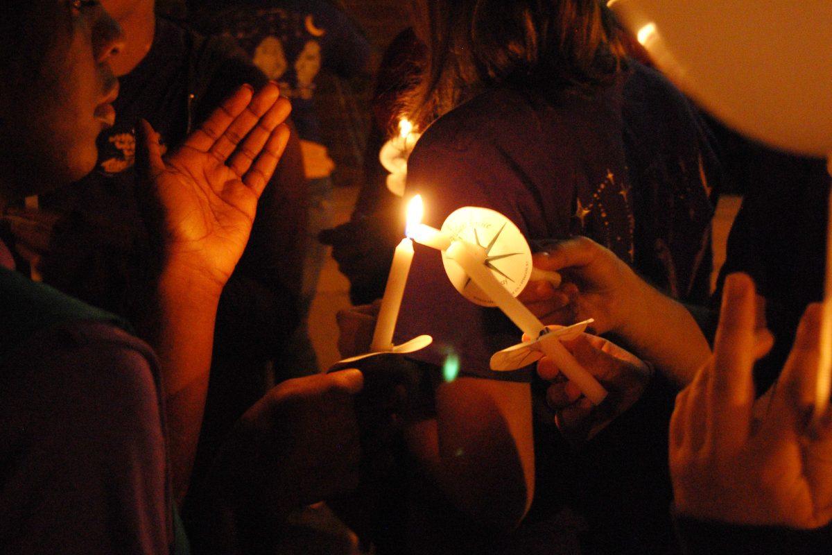 Students light candles during “Take Back the Night” on Oct. 28, 2010.