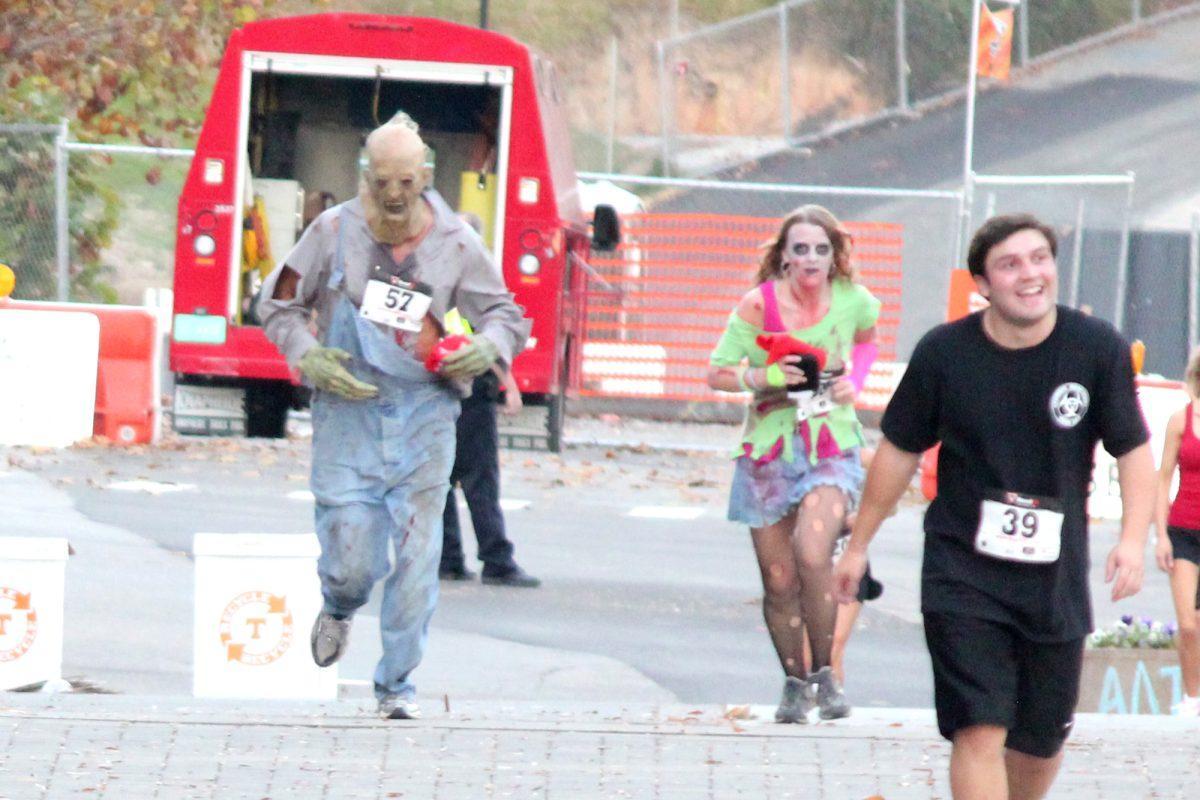 Participants dress up in their zombie best during the zombie-themed "Clinic Vols Friday Night 5K" event on Oct. 26.