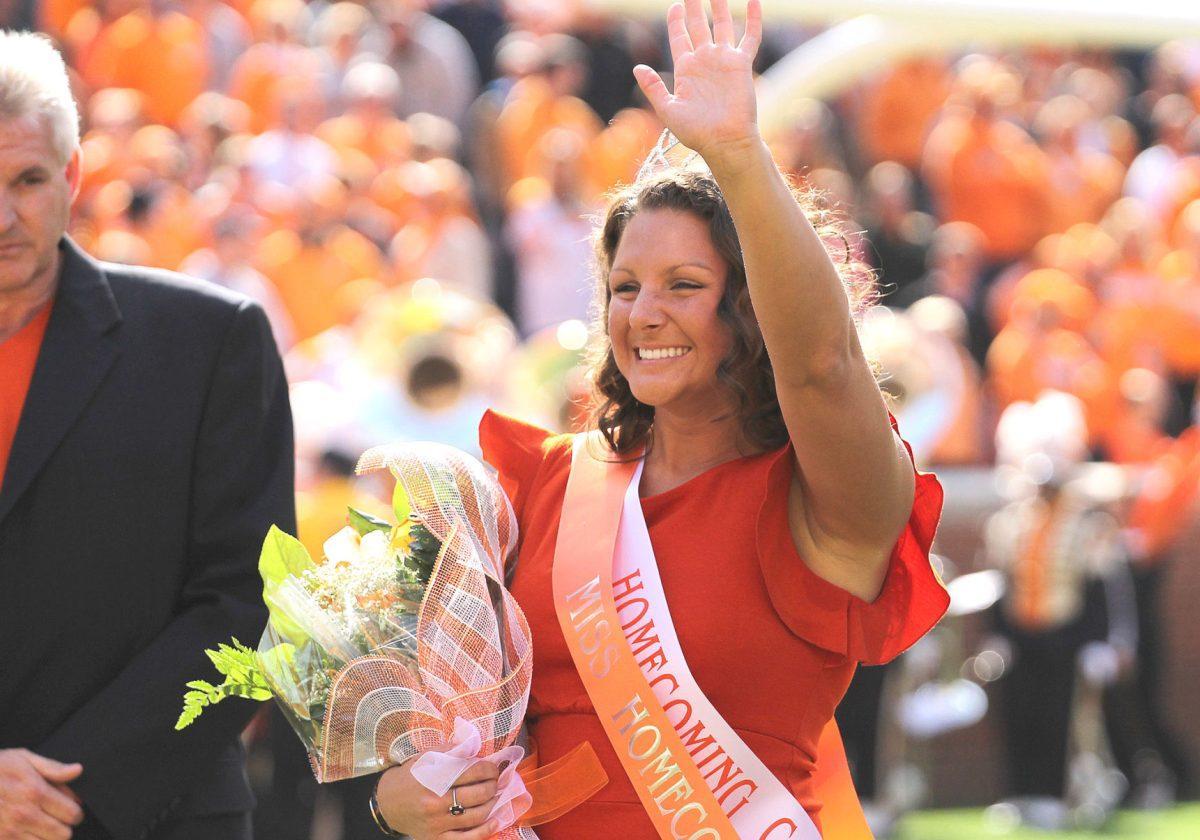 Katie Arnold, senior in nursing, waves to the crowds after being announced Miss Homecoming 2012.