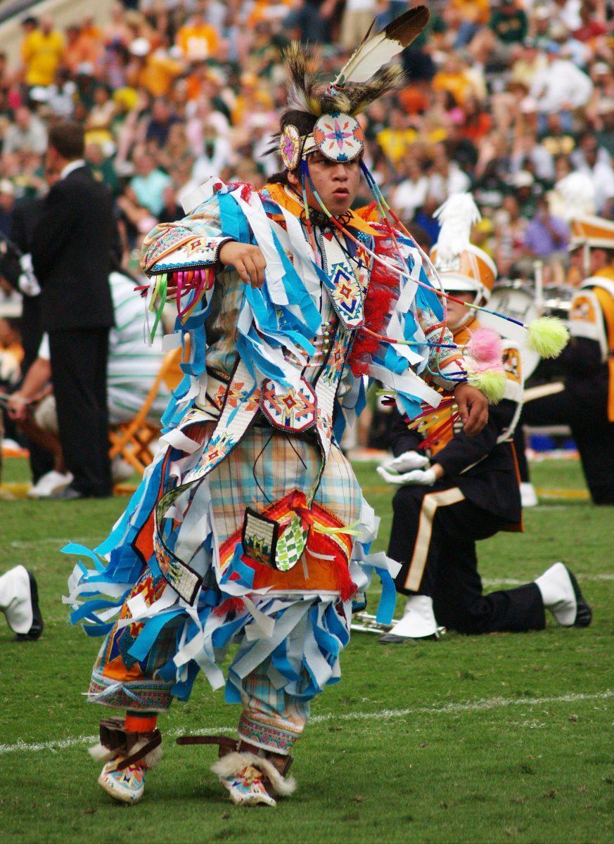 A member of the Native American Student Association dances in full regalia during a football halftime show on Sept. 26, 2010.
