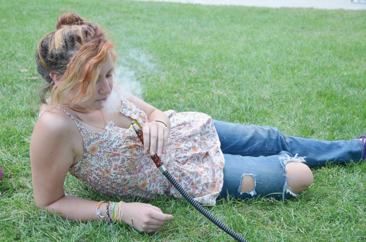 Bridget Daunais, junior in studio art, smokes hookah in the Humanities Amphitheatre on Monday, Sept. 12, 2011.