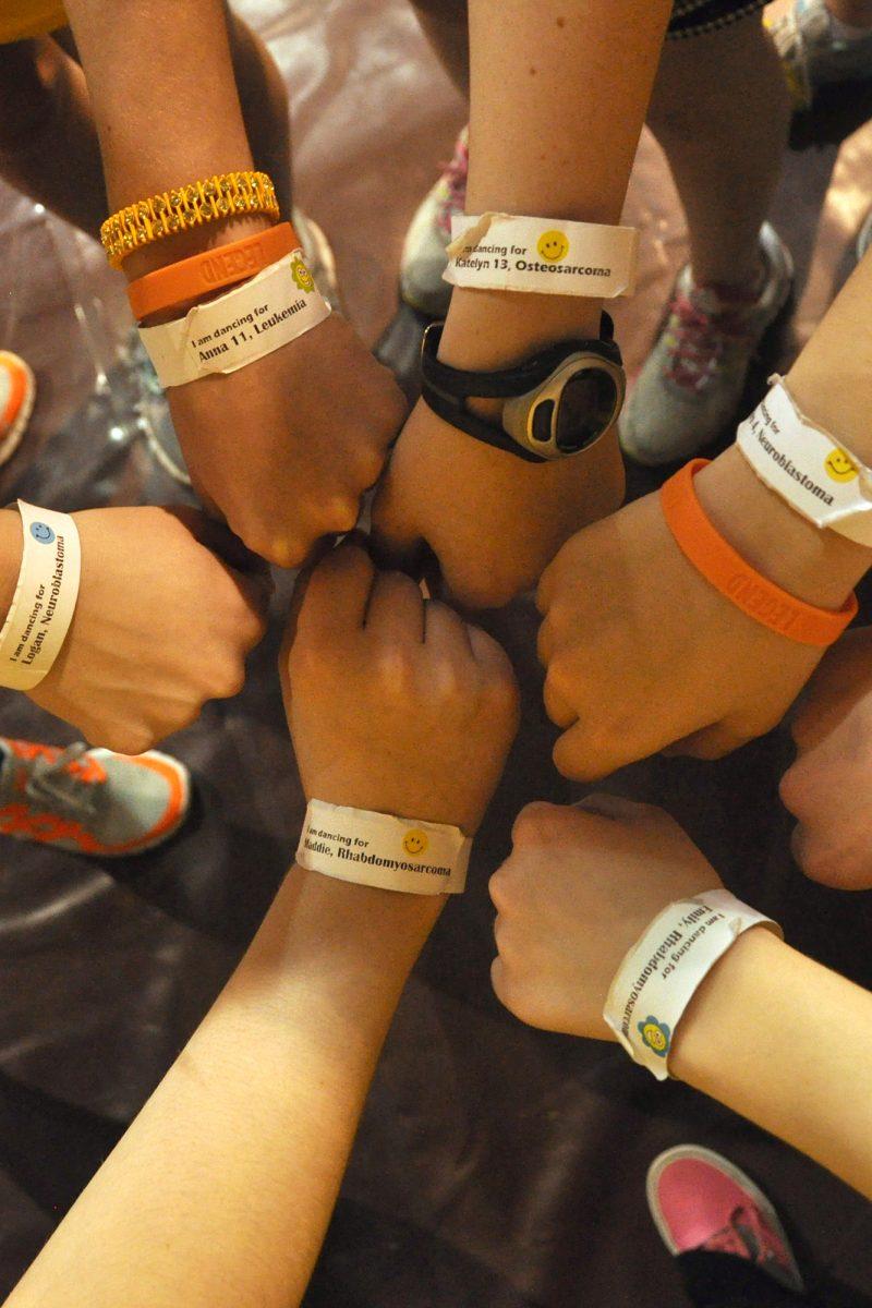 Students display wristbands in honor of children facing cancer during Dance Marathon. Dance Marathon is an event put on by the Center for Leadership and Service.