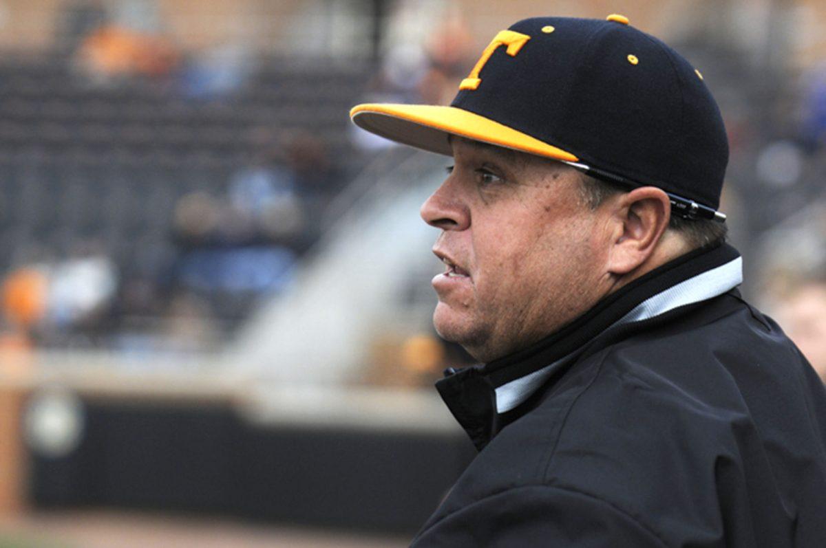 Baseball head coach Dave Serrano shouts to players on the field during a game last season.