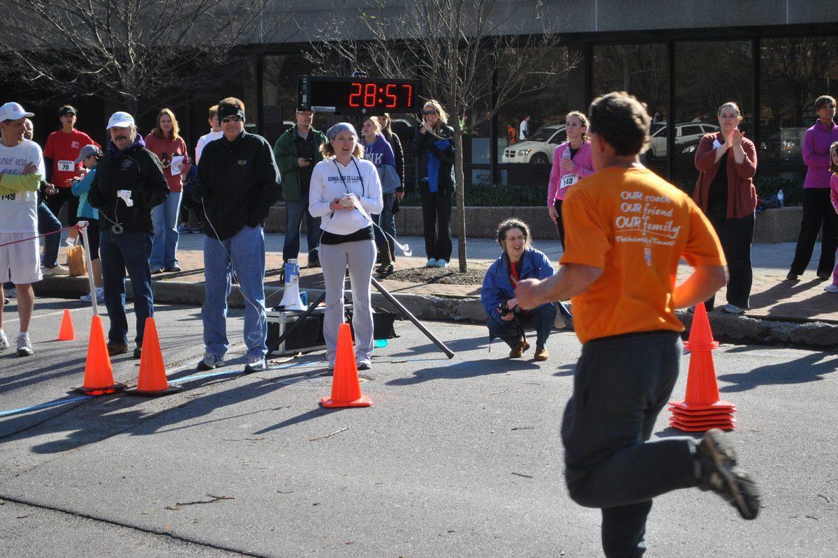 Members of the Knoxville community watch as participants in the 5K cross the finish line on March 3, 2011.The 21st annual "Love Your Libraries 5K Race" to benefit the Knoxville libraries will take place on March 2.