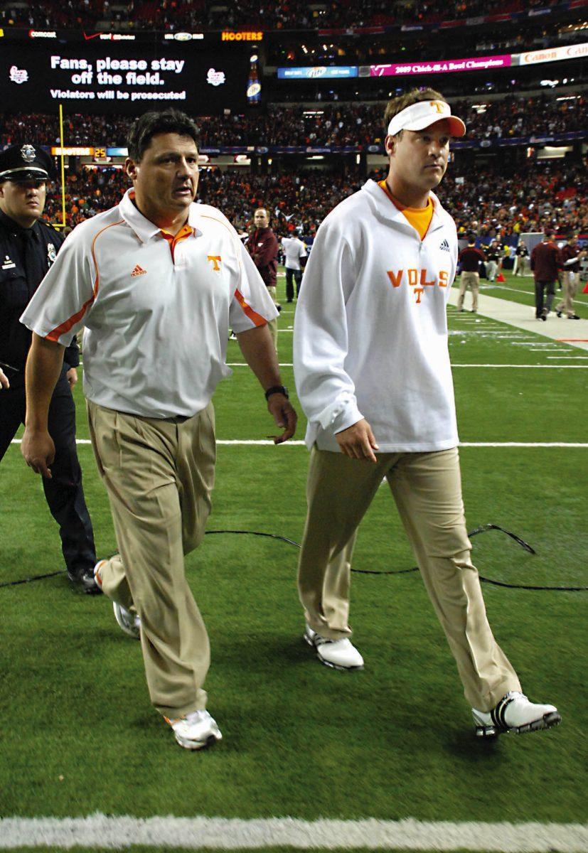 Lane Kiffin and Ed Orgeron walk off the field after the Chick-fil-A bowl in 2009.