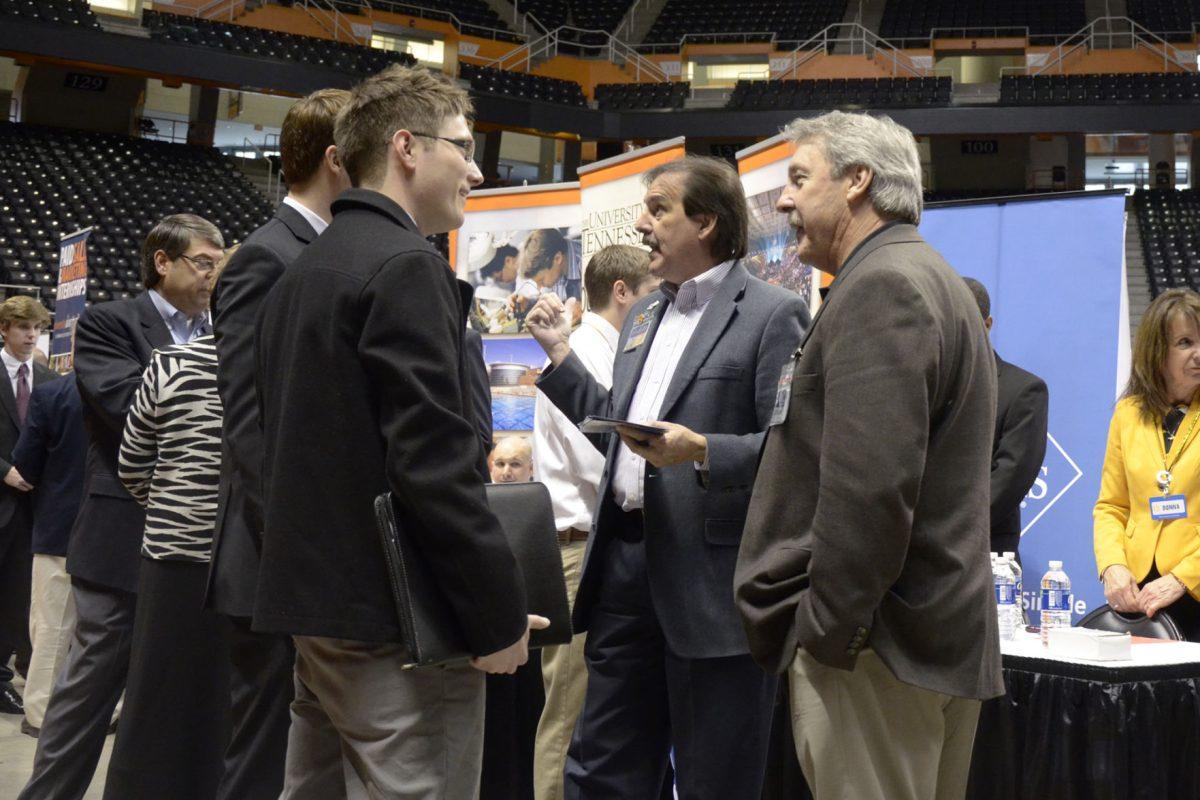 Representatives give prospective students more information about the job opportunities at their companies at the 2013 Spring Job and Internship Fair at Thompson Boling-Arena on Tuesday.