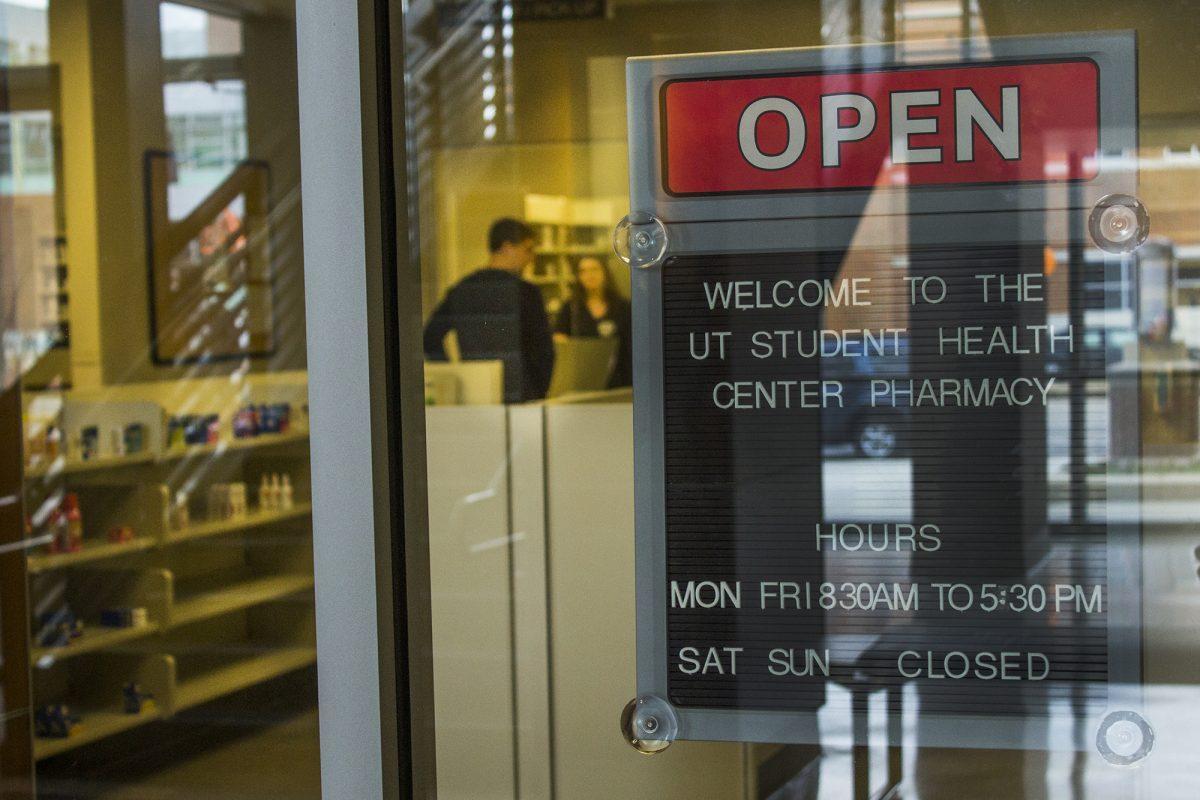 A student receives a prescription from the newly opened pharmacy in the UT Student Health Center during the open house on Tuesday. The new pharmacy offers students an on-site pharmacy to refill prescriptions or obtain medication.