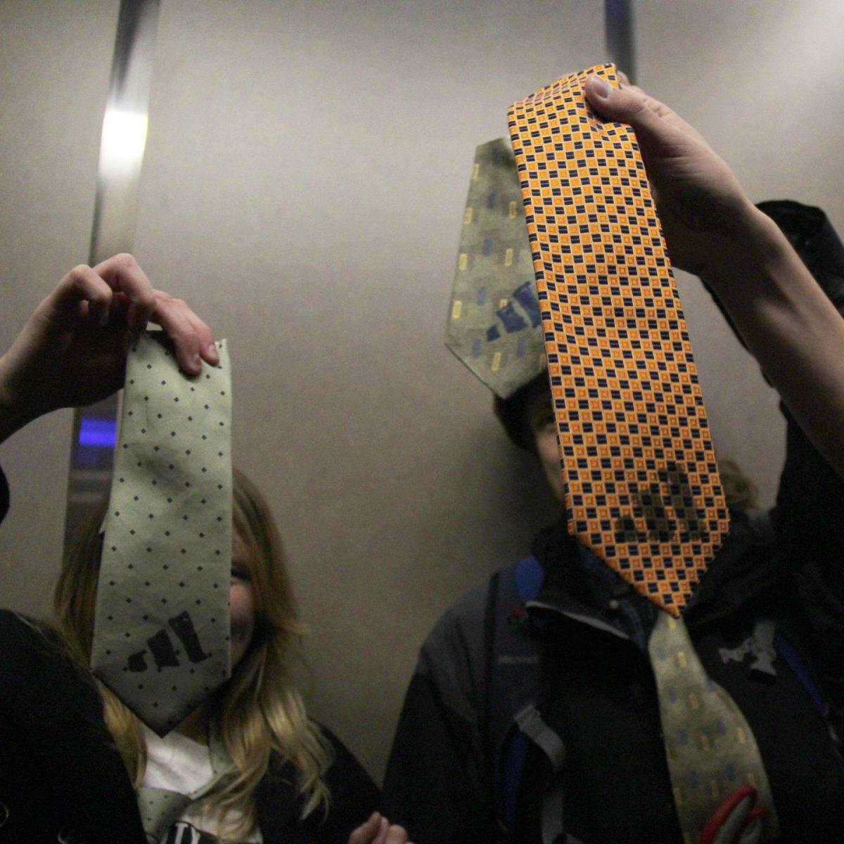 Students show their cut ties with the adidas logo after visiting the office of UT System President Joe DiPietro on March 8.