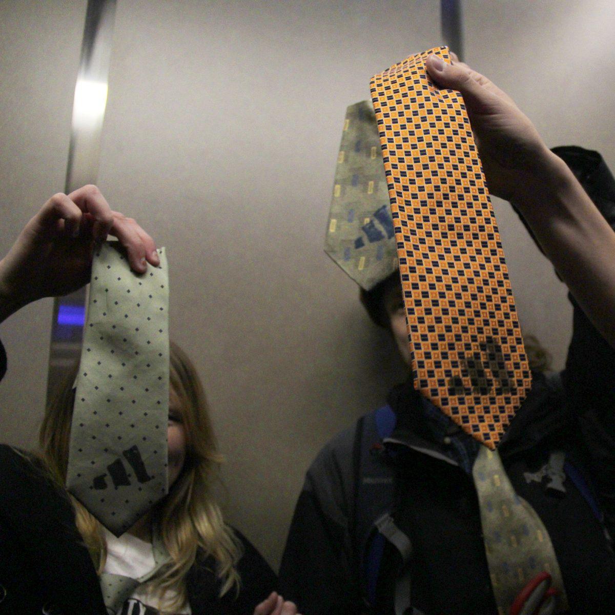Students show their cut ties with the adidas logo after visiting the office of UT System President Joe DiPietro on March 8.