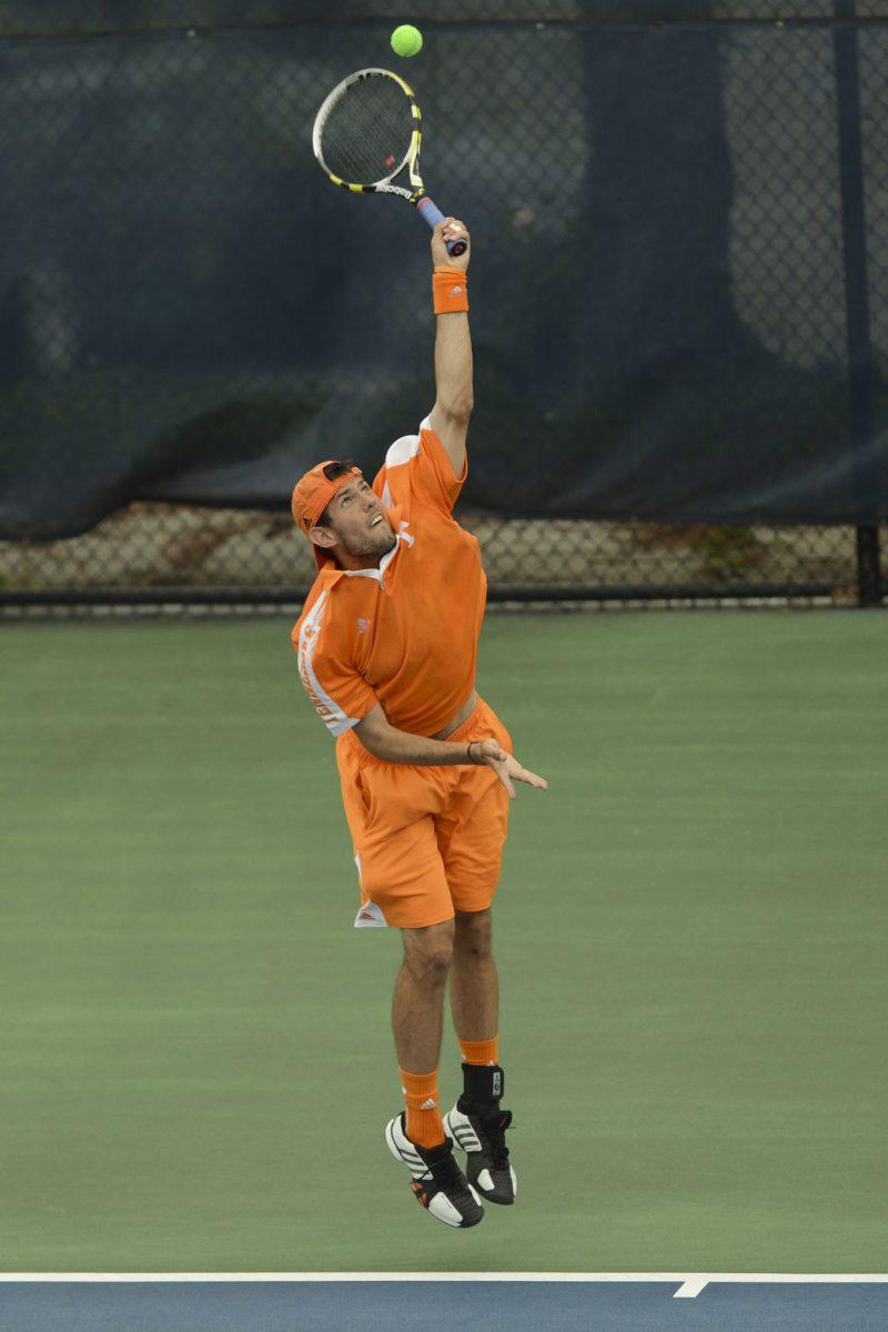 Senior John Collins serves with intensity against the Auburn University Tigers at Barksdale Stadium on April 14.