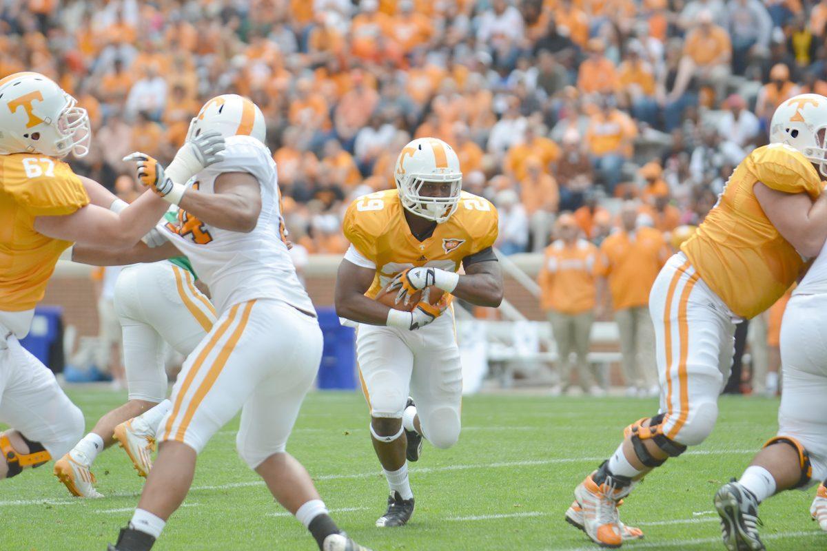 Sophomore running back Tom Smith finds a hole in the defense during the Orange and White game on April 21, 2012