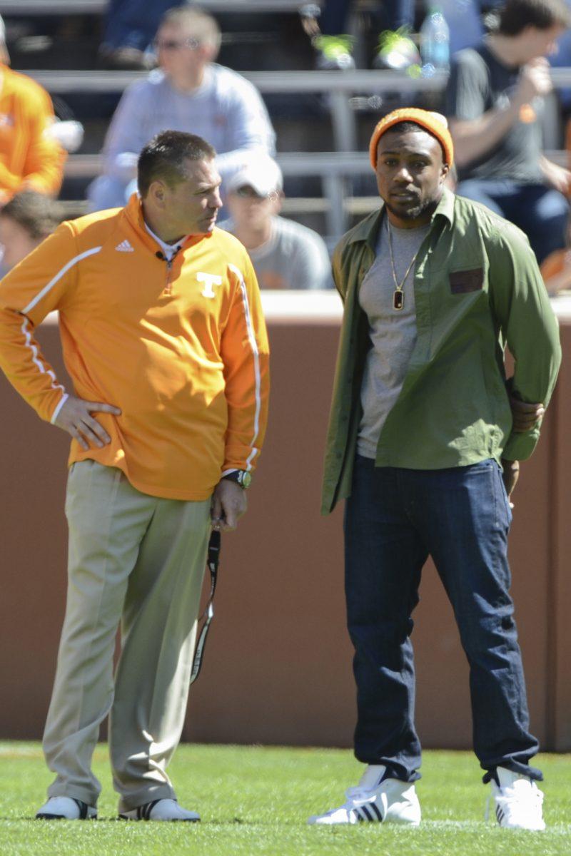 Head coach Butch Jones talks to former Volunteer safety Eric Berry during the Orange and White game on April 20.