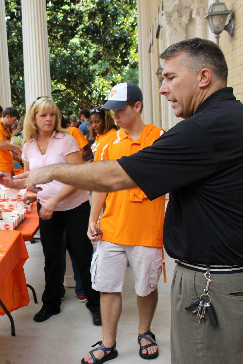 Ray Morgan, Zone Director of Krystal's, direct students to the concession table at Unite Tailgate on Aug. 28