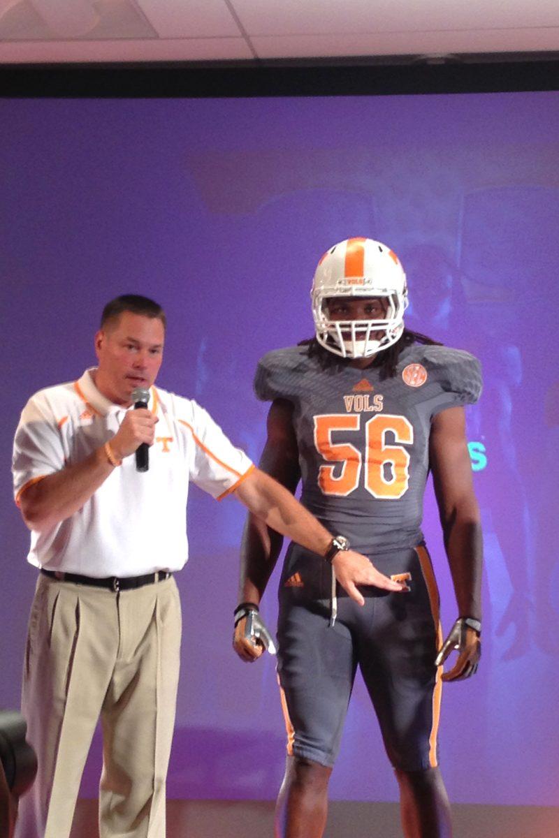 Butch Jones points out the intricacies on UT's new "smokey" colored jersey. The Vols will wear the new uniform in one game during the 2013 season.