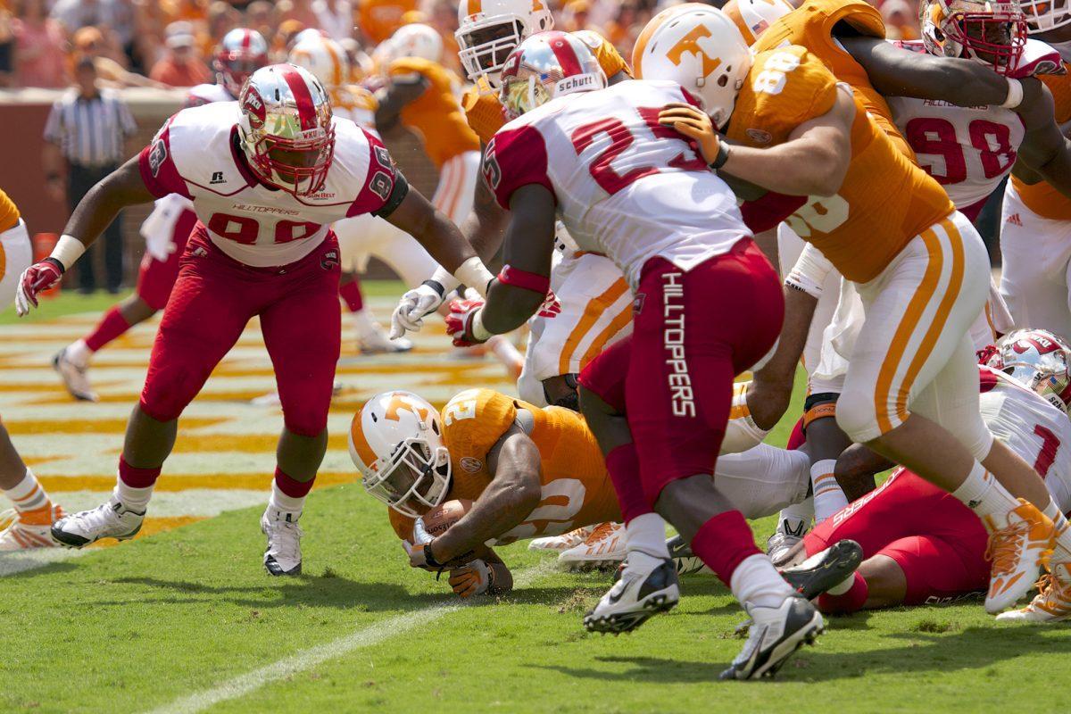 Running back Rajion Neal bounces off Western Kentucky defenders to score in Tennessee's 52-20 win over Western Kentucky at Neyland Stadium on Saturday, Sept. 7.