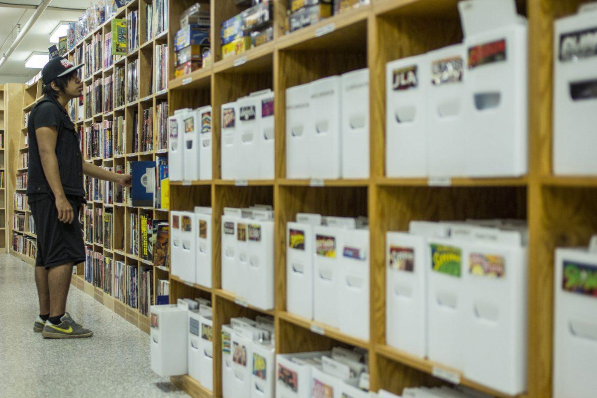 Comics fan Brandon Severiano looks for books starring Green Lantern at McKay Used Books, CDs, Movies and More on Sept. 24.