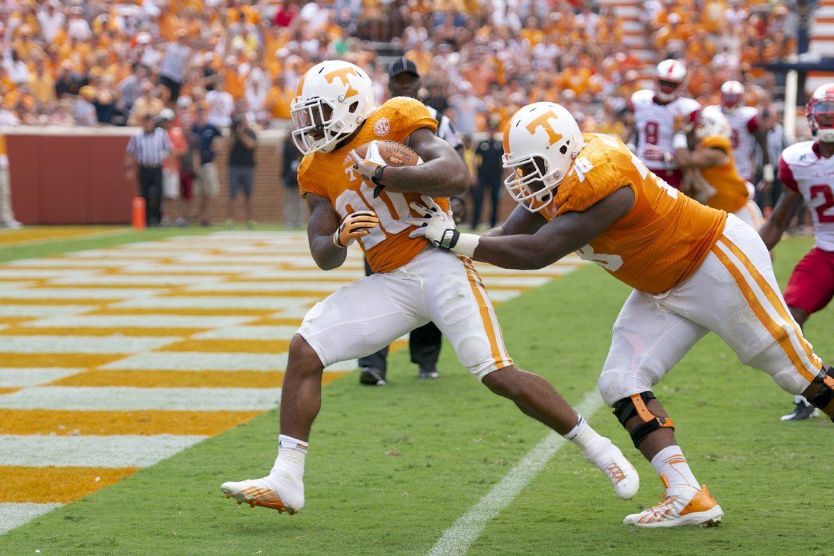 Offensive lineman Alex Bullard, right, pushes running back Rajion Neal into the endzone for a touchdown against Western Kentucky on Saturday, Sept. 7. Neal registered three rushing touchdowns against the Hilltoppers.