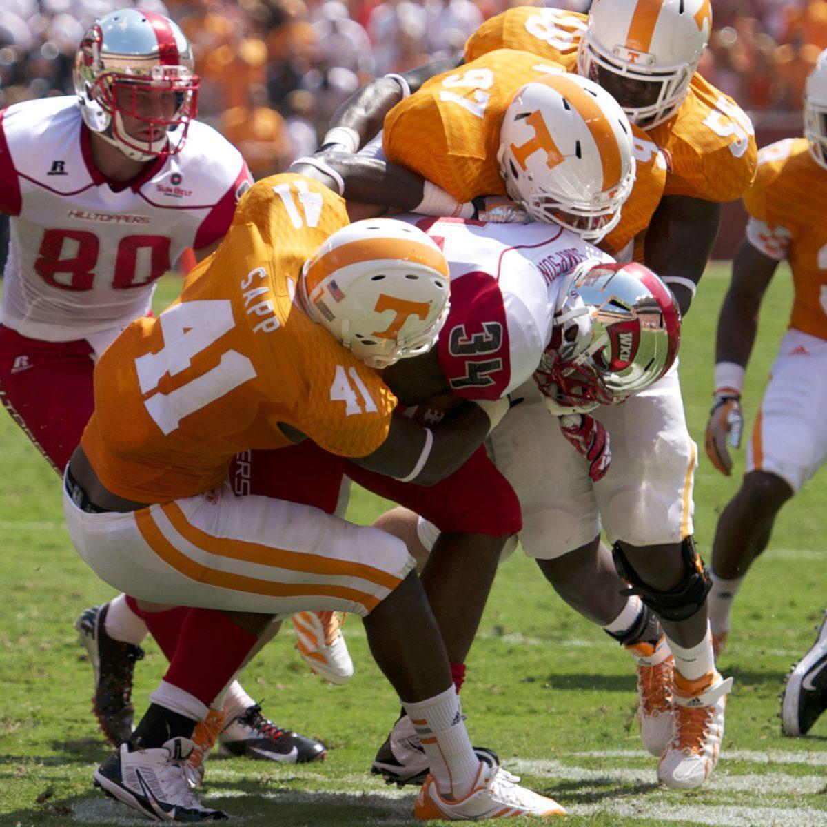 Linebacker Dontavis Sapp, No. 41, along with a host of Volunteer defenders tackle Western Kentucky running back Drew Davis at Neyland Stadium on Saturday, Sept. 7.