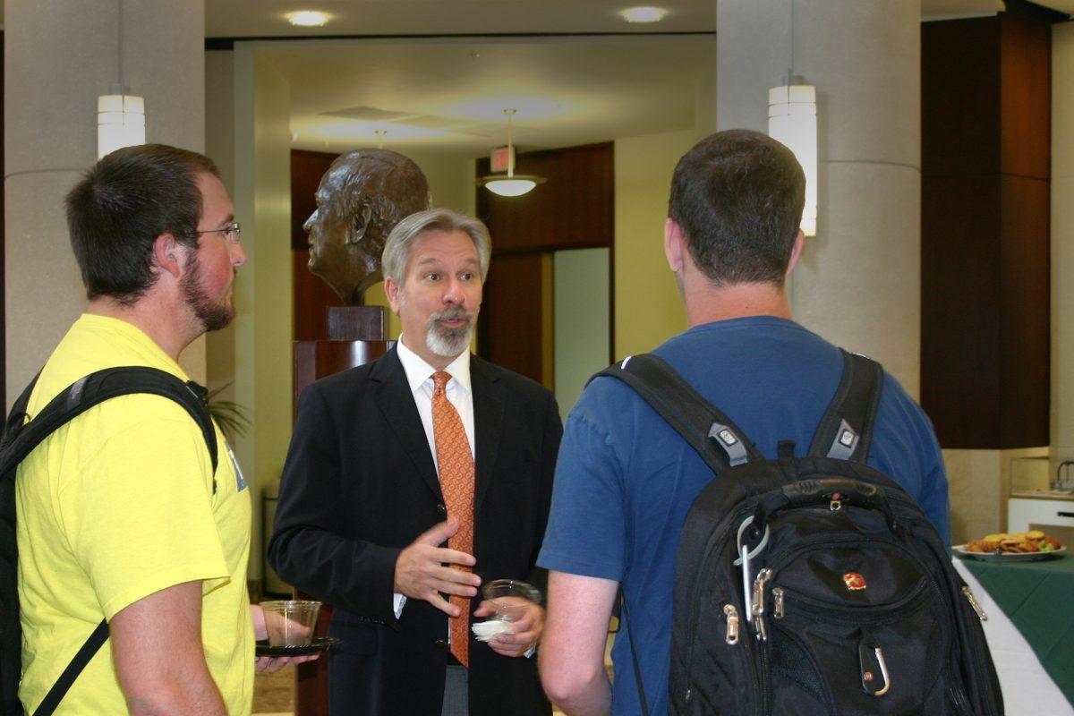 Andrew Harris, left, a sophomore in business analysis, and Adam Wright, sophomore in history, talk with new Honors Provost Timothy Hulsey in the Baker Center on Sept. 11.