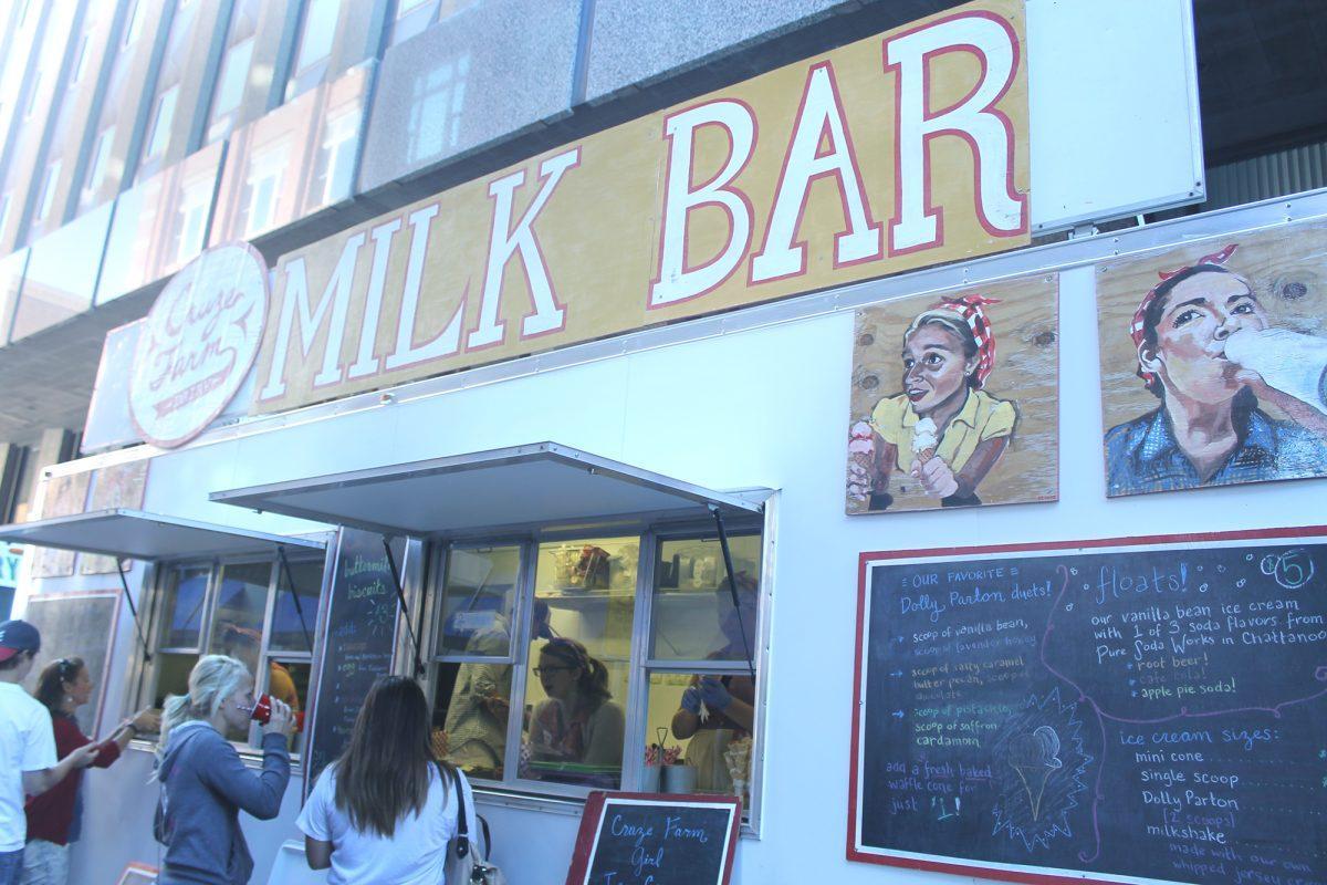 Workers at Cruze Farm's Milk Bar serve milk and ice cream from a food truck on Union Ave. during the Farmers Market on Sept. 14.