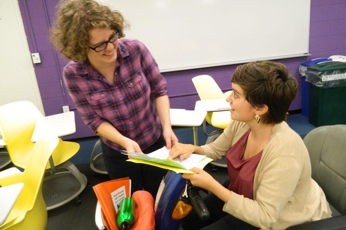 Lindsey Lee, right, senior in math and Spanish, reviews documents gathered from the Inclusive Transportation Survey meeting with Kathleen Connelly on Sept. 17.